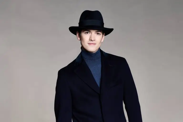 man wearing a dark navy blue hat over a matching coat