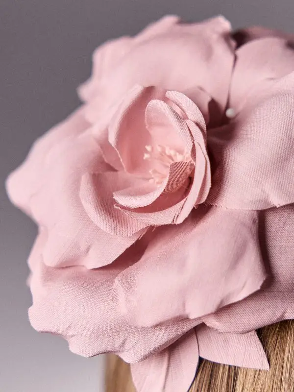 Focus on the Althaea rosé silk flower of the headband