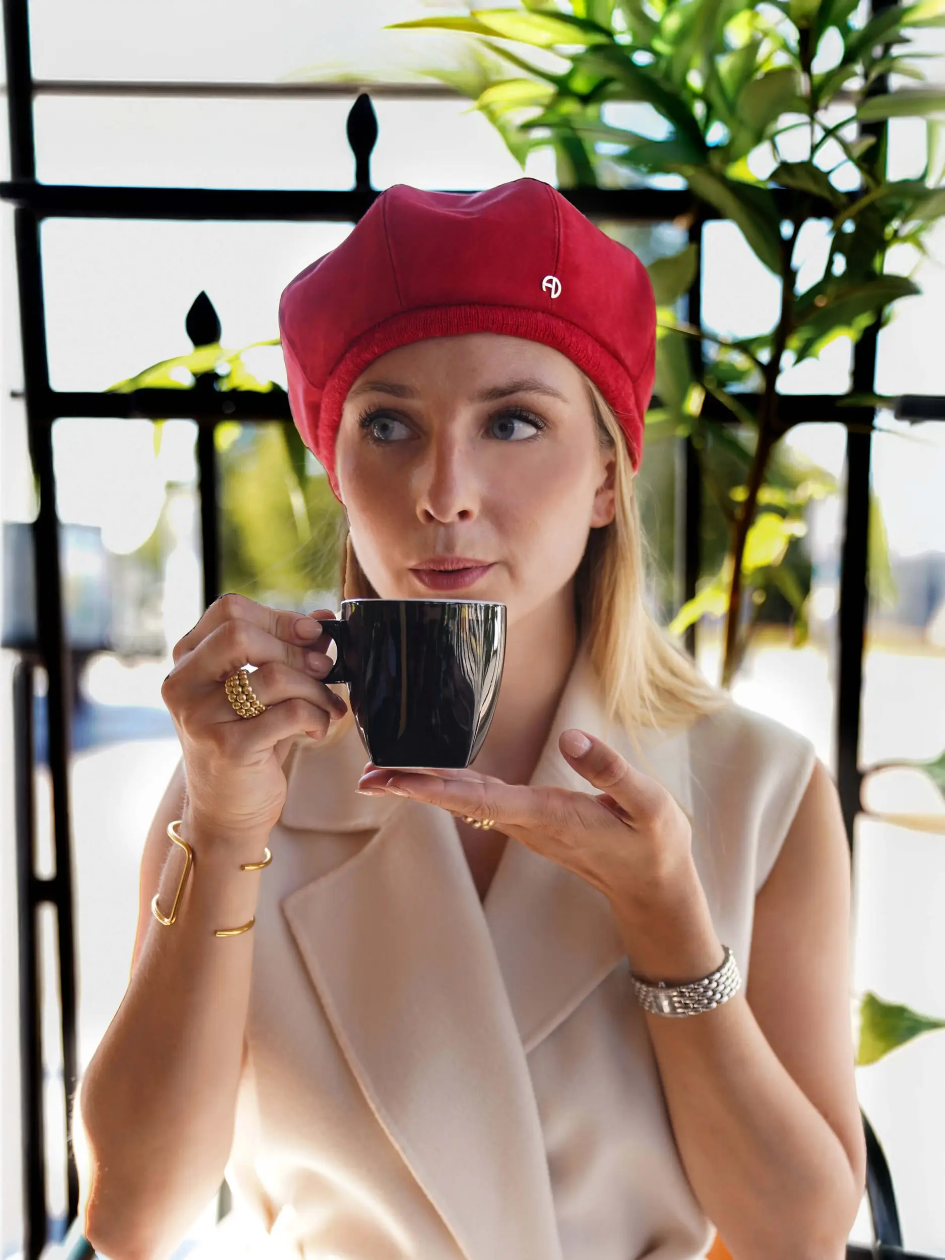 Woman wearing the red poppy hat in a cafe