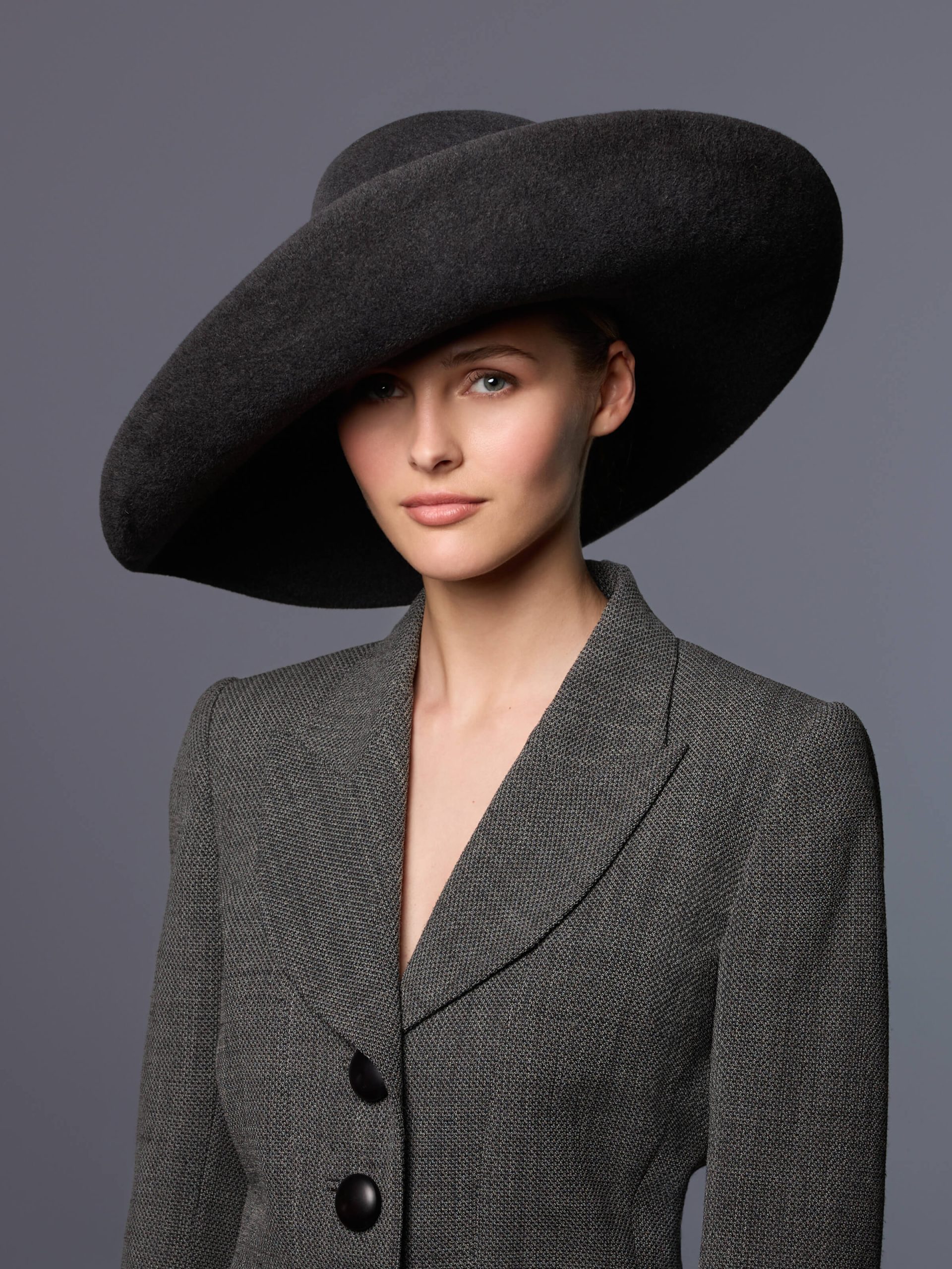 Mannequin wearing a dark grey velour felt floppy hat with a turned-up brim