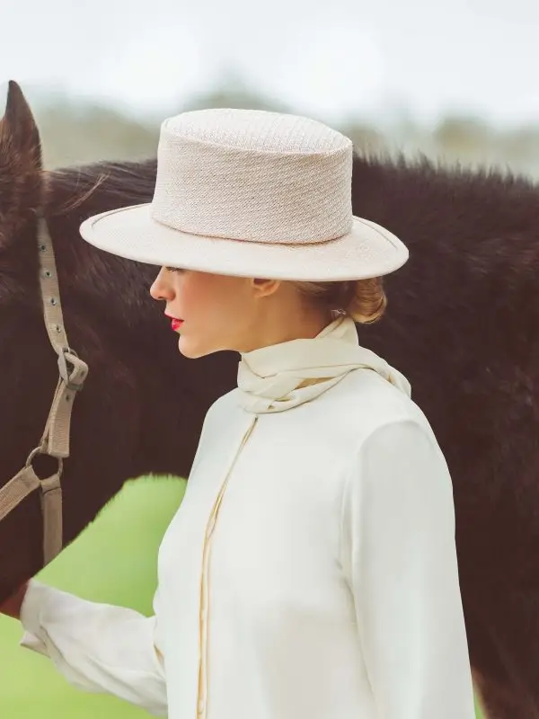 Mannequin wearing the white Cavallo boater hat accompanied by a horse