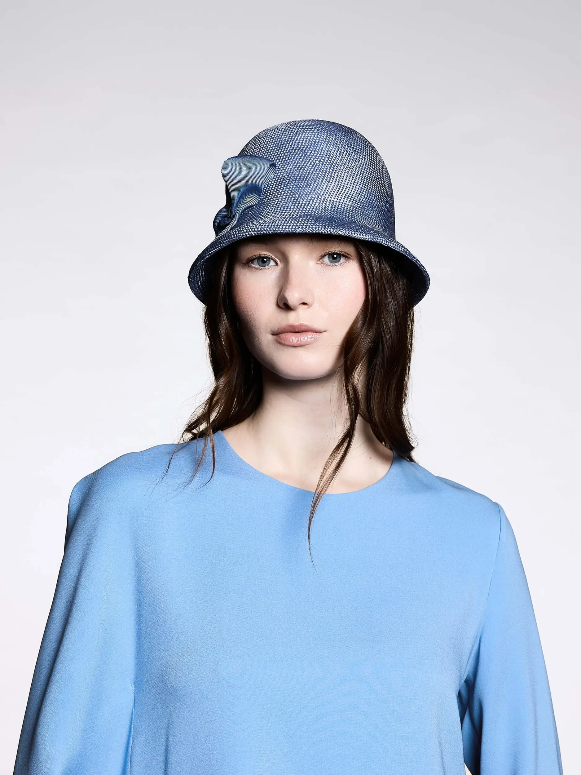 Mannequin wearing the sky blue Talina cloche hat to match her outfit