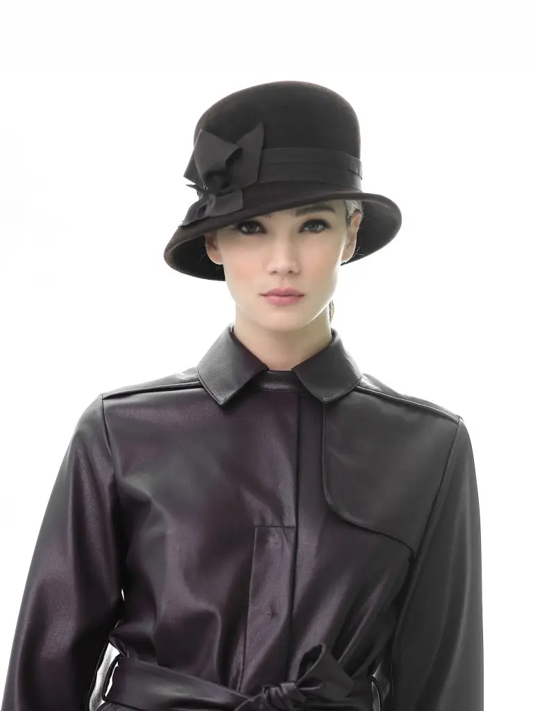 Woman wearing Brunela rain hat in burgundy felt by Maison Fabienne Delvigne