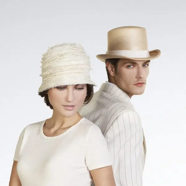 Mannequin man wearing a top hat and the woman a cloche hat