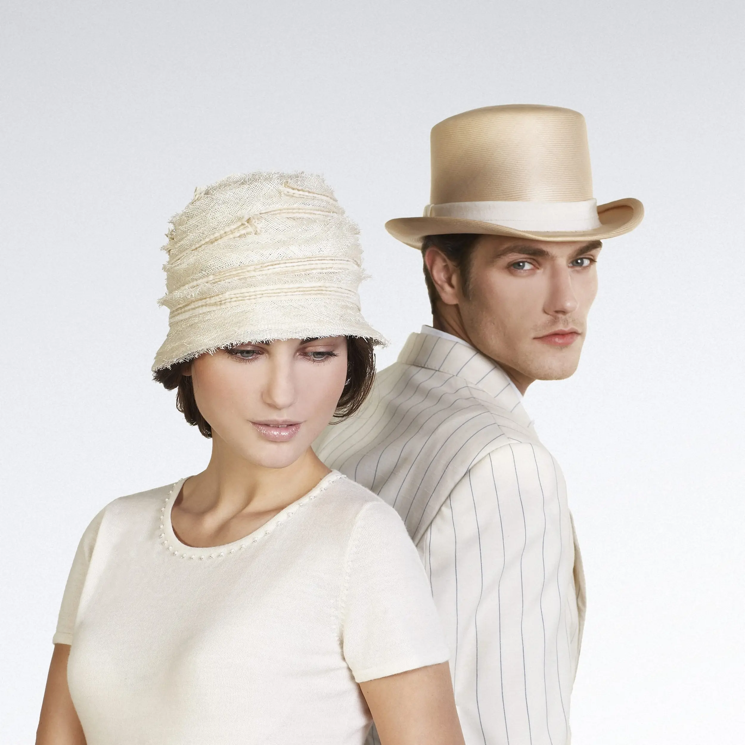 Mannequin man wearing a top hat and the woman a cloche hat