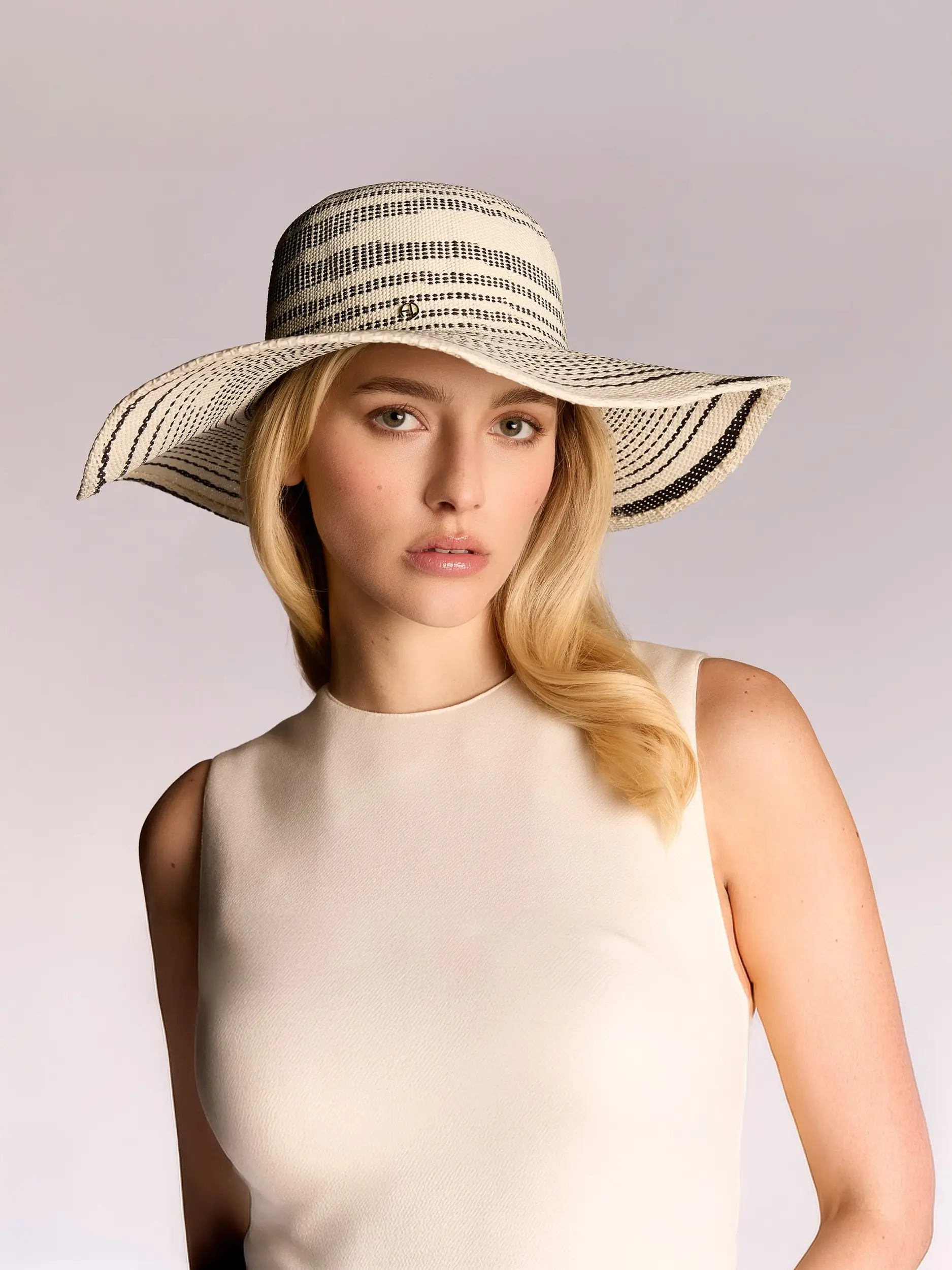 Woman wearing the black and white Turin panama hat by Maison Fabienne Delvigne