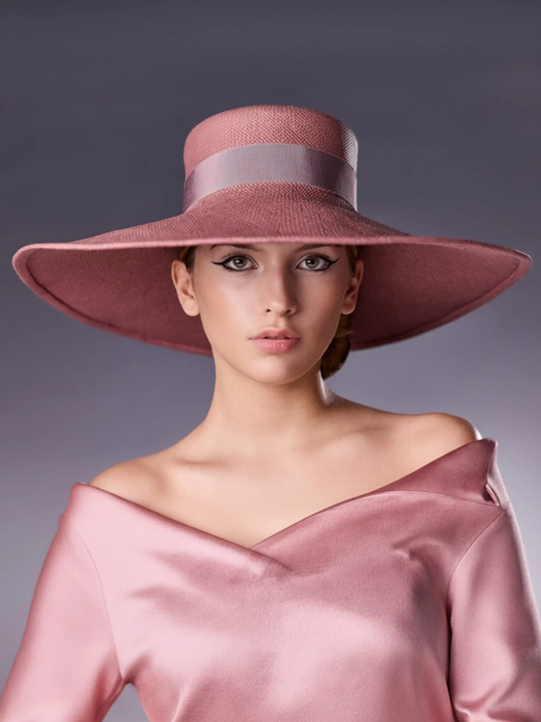 Model wearing the Elina rose Panama hat by Maison Fabienne Delvigne