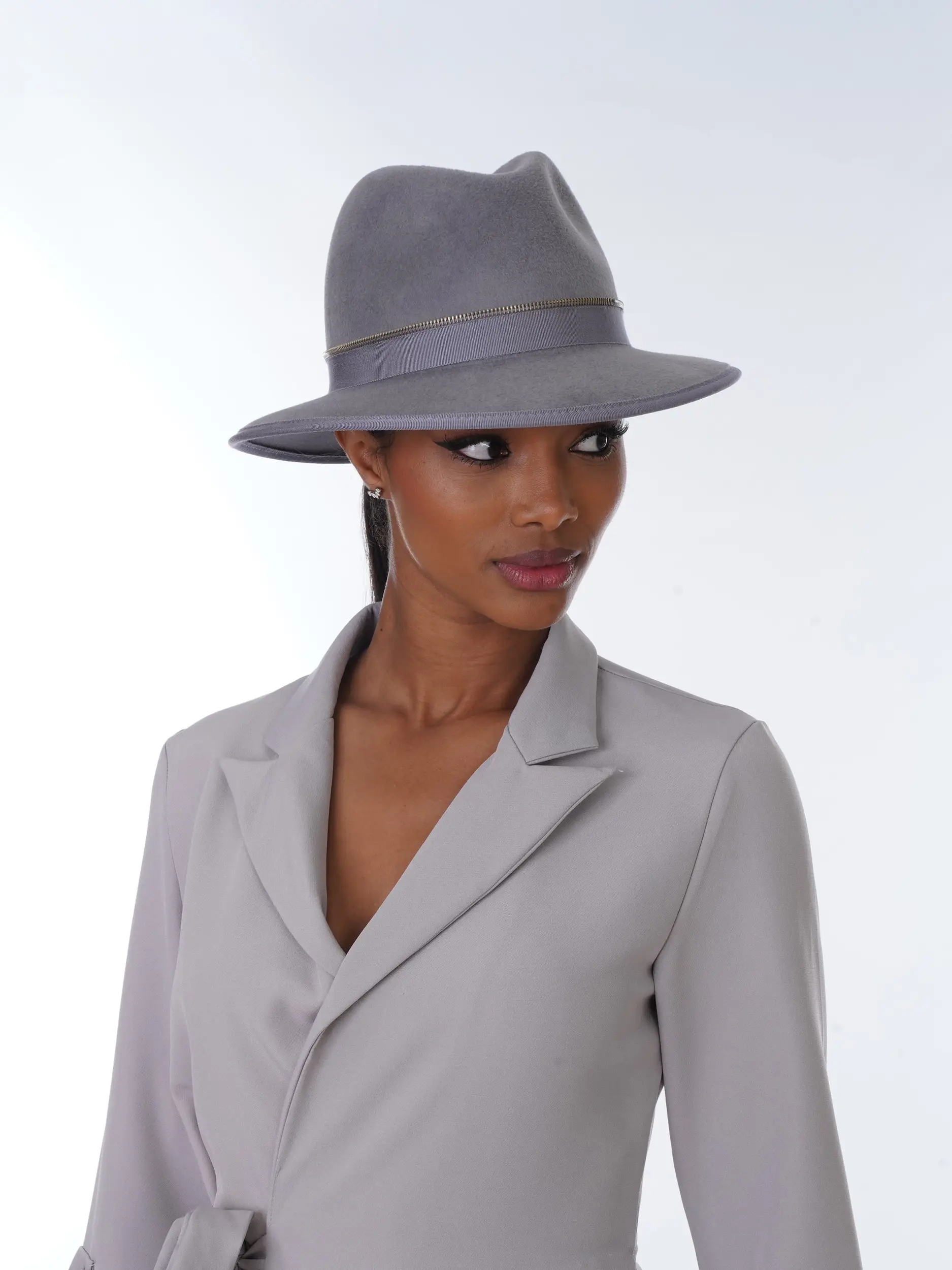 Mannequin wearing the Kathy rain fedora hat made of grey velvet felt matched to her outfit