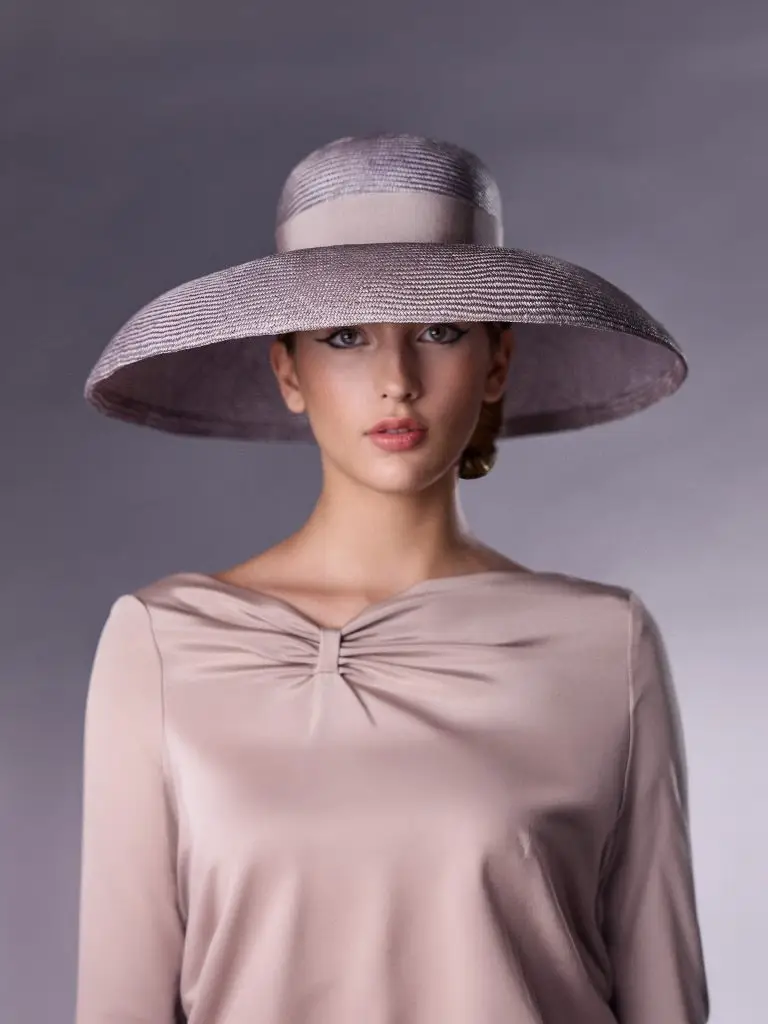 Woman wearing a large lilac bell-shaped hat