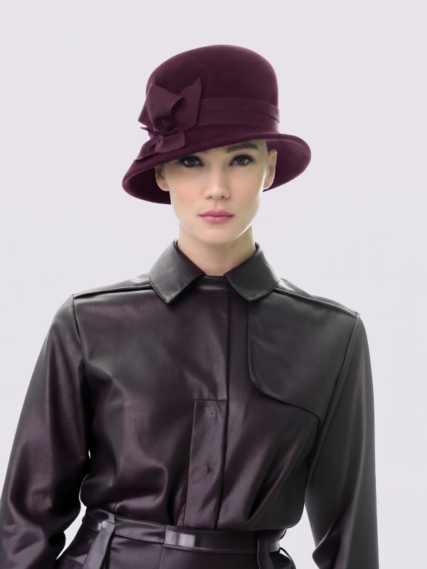 Woman wearing Brunela rain hat in burgundy felt by Maison Fabienne Delvigne